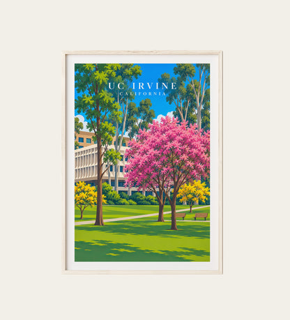 UC Irvine California campus travel poster in a light wood frame – pink blooming tree and eucalyptus on a sunny campus lawn